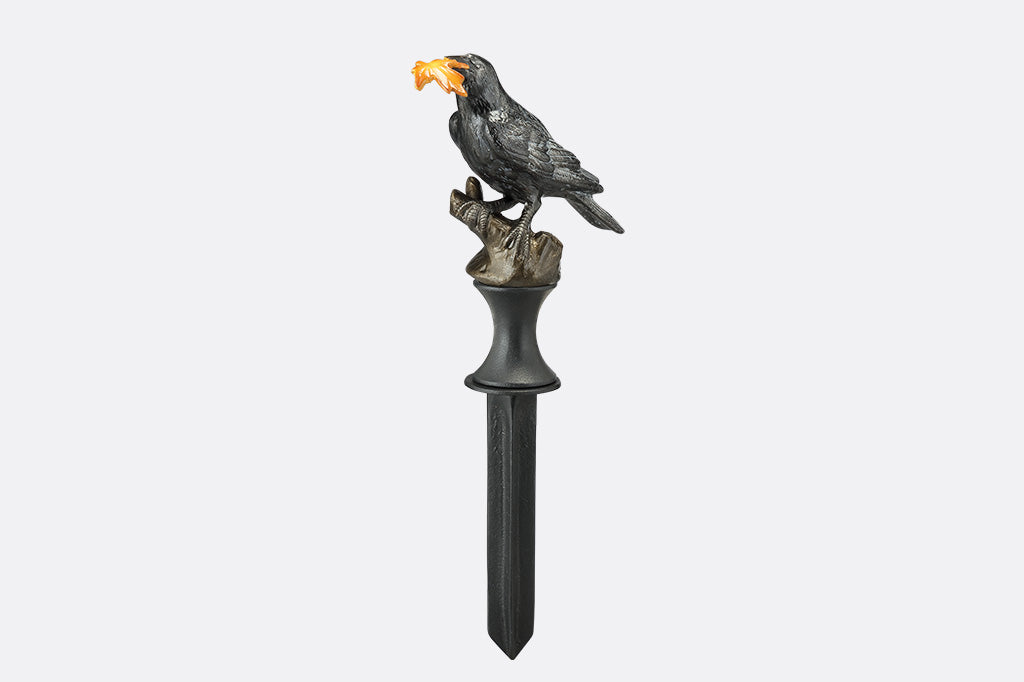 Decorative hose guard with a bird holding a leaf on a white background