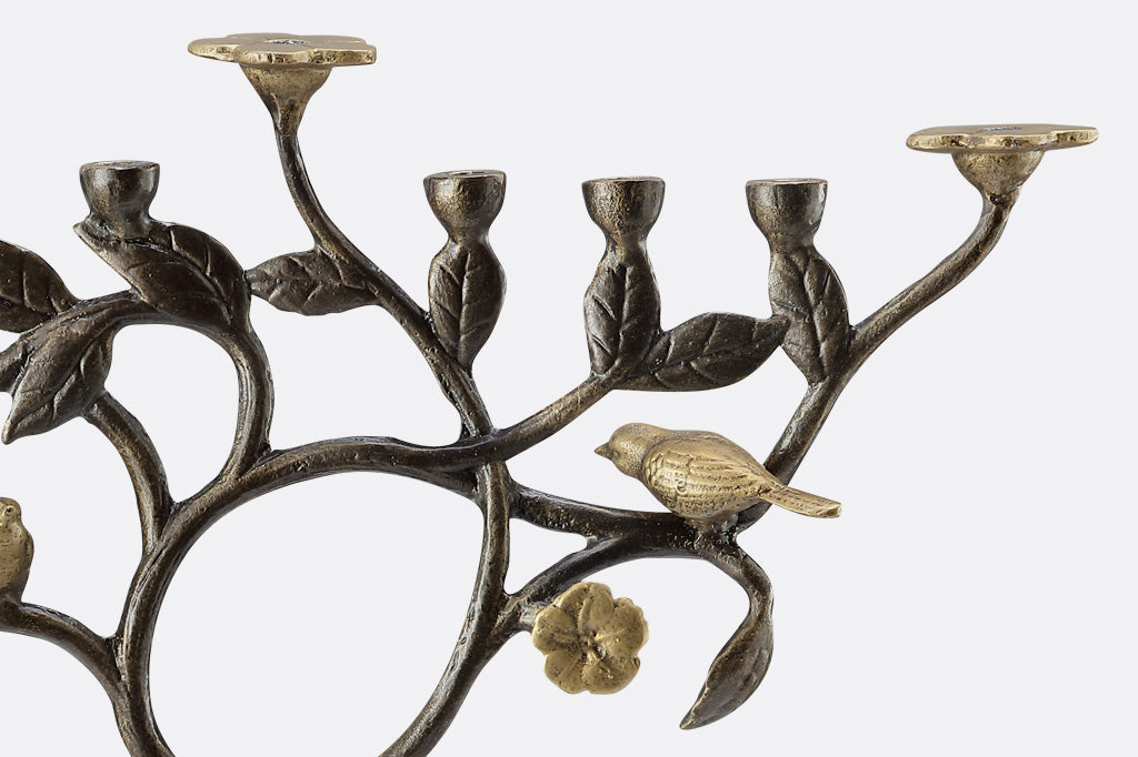 Close-up Detail of cast aluminum menorah with bird and leaf design
