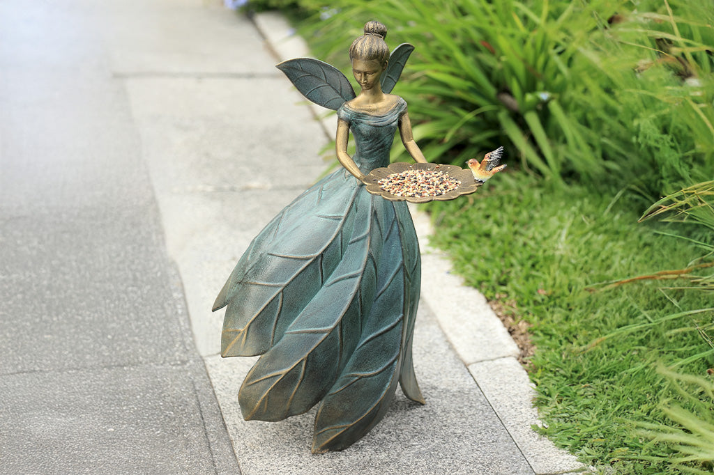 A hovering fairy with a flowing dress with a platter birdfeeder.