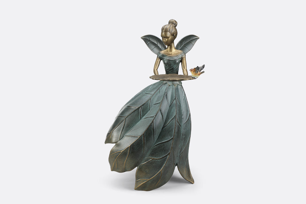 A hovering fairy with a flowing dress with a platter birdfeeder.