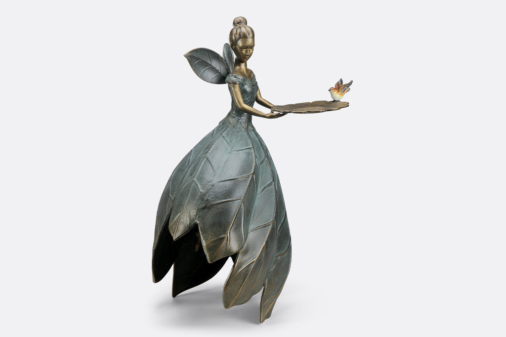 A hovering fairy with a flowing dress with a platter birdfeeder.