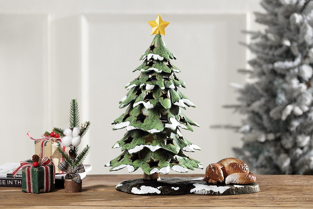 Decorative Christmas tree figurine with a star on top and a fox at its base.