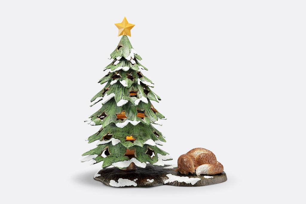 Decorative Christmas tree figurine with a star on top and a fox at its base on a white background
