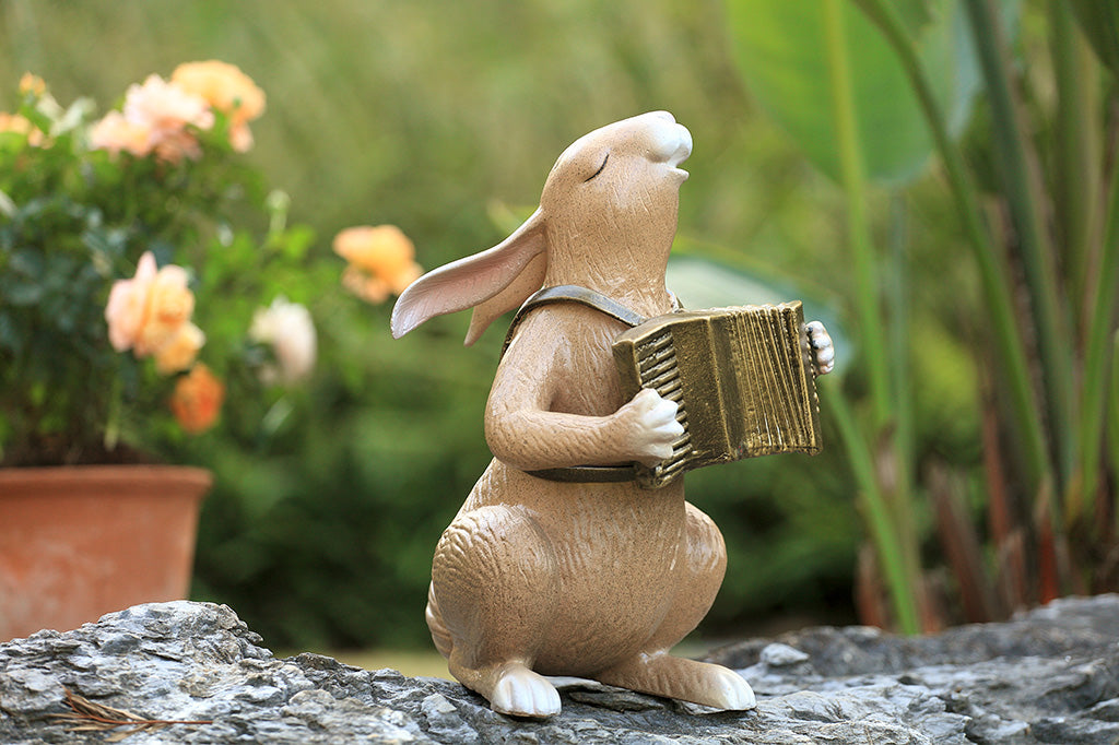 A sculpture of a bunny playing an accordion.