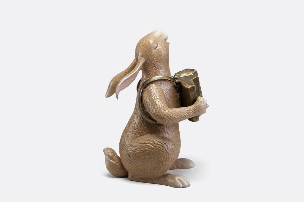 A sculpture of a bunny playing an accordion.