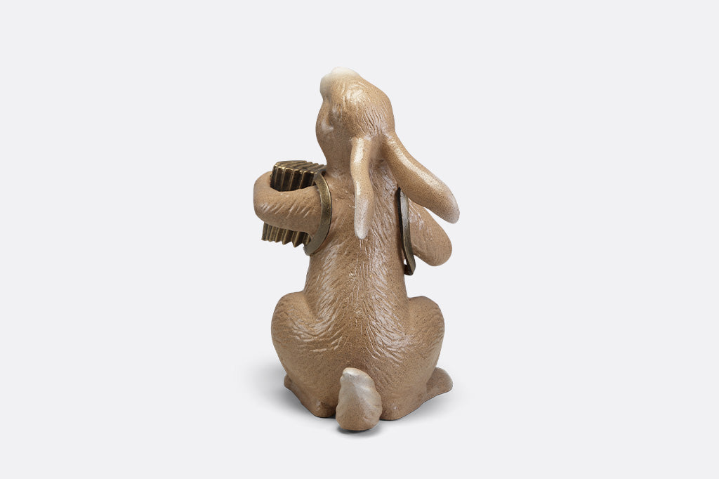 A sculpture of a bunny playing an accordion.