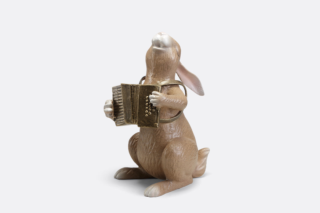 A sculpture of a bunny playing an accordion.