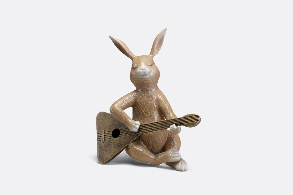 Sculpture of a bunny playing a guitar.