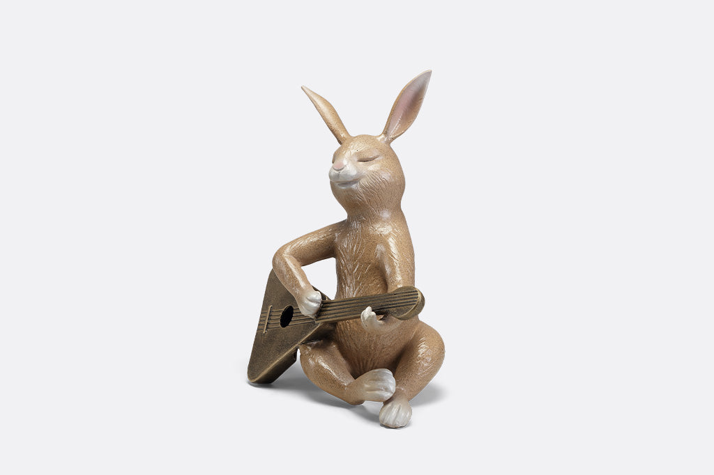 Sculpture of a bunny playing a guitar.