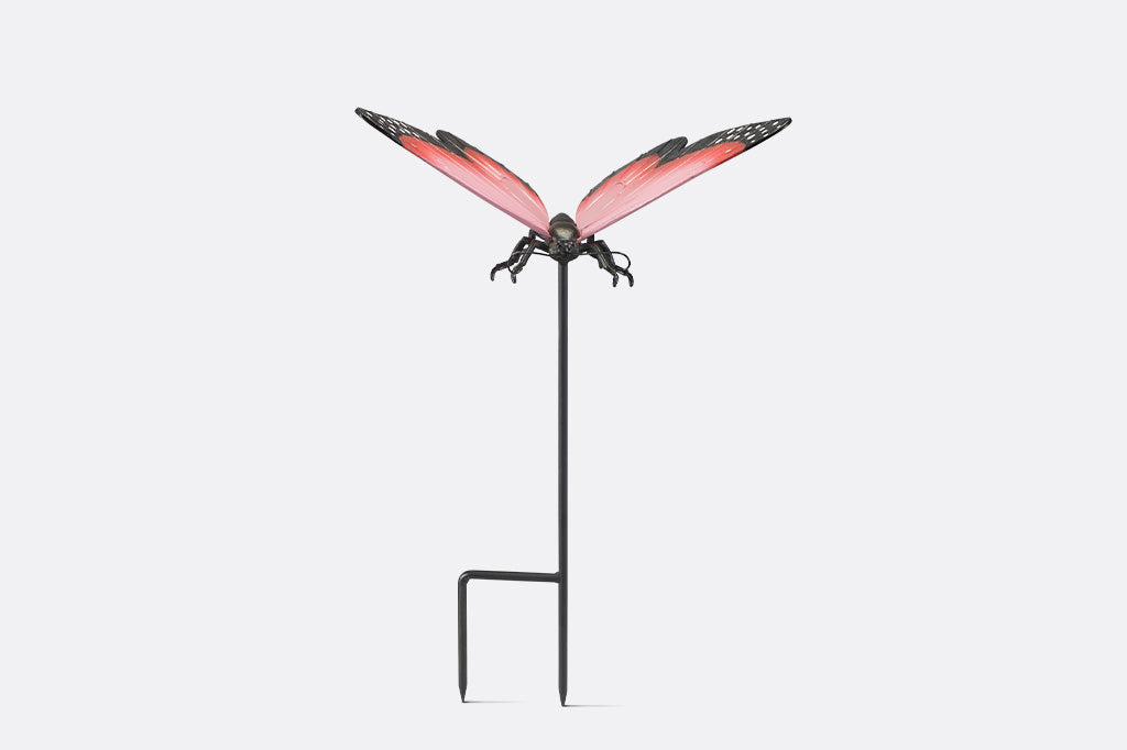 A garden stake sculpture of a pink, red,  and black butterfly.
