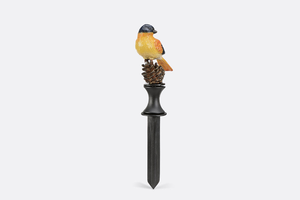 Decorative garden stake with a bird and pine cone design on a white background