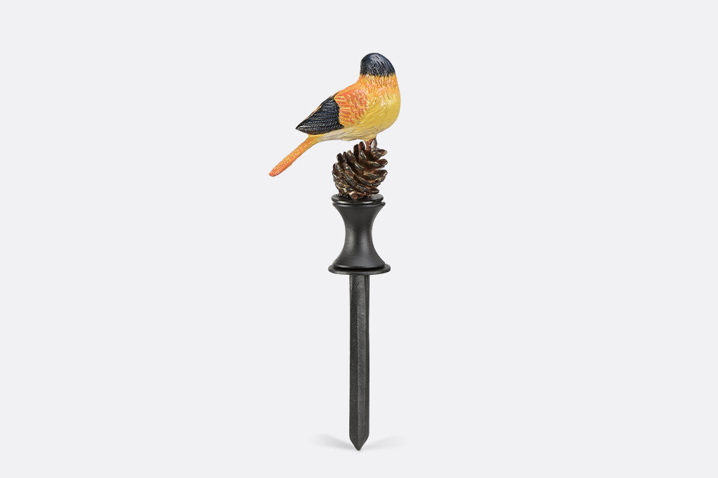 Decorative garden stake with a bird and pine cone design on a white background