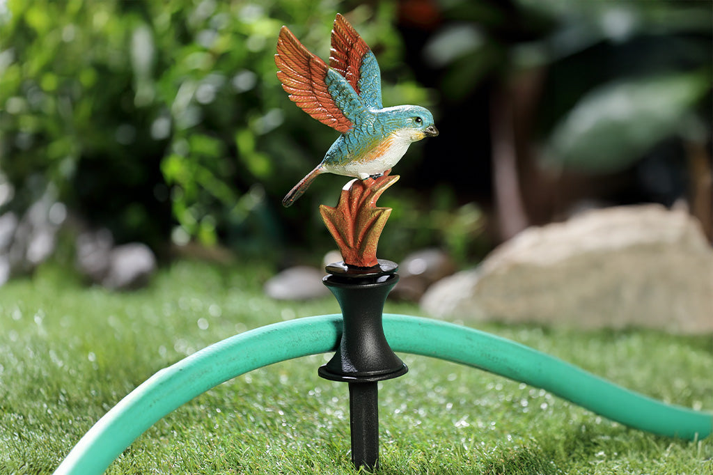 A hose guard of a bird landing upon a leaf.