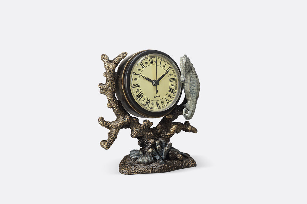 Clock with organic ocean like inspired design and a seahorse attached from side angle