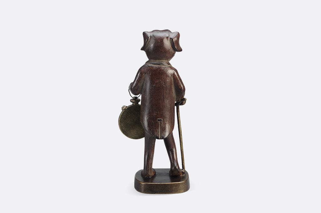 Back of Bronze statue of a dog with a pocket watch on a white background