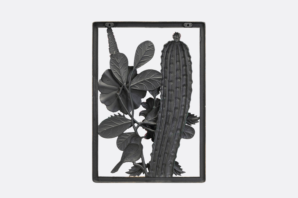 A decorative wall art of a desert scene with cacti, flowers, and birds.