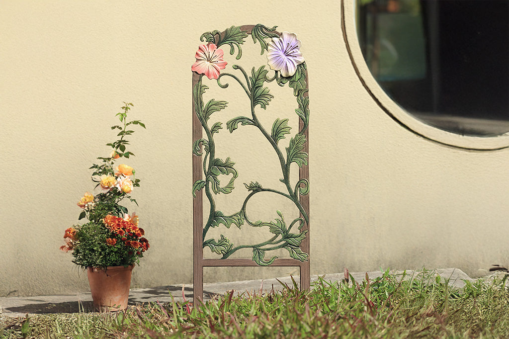 A decorative garden trellis featuring blooming lilies and branches.