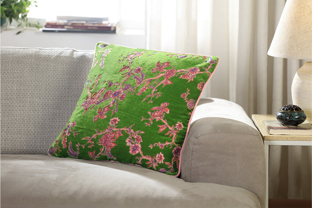 Green pillow with pink floral pattern