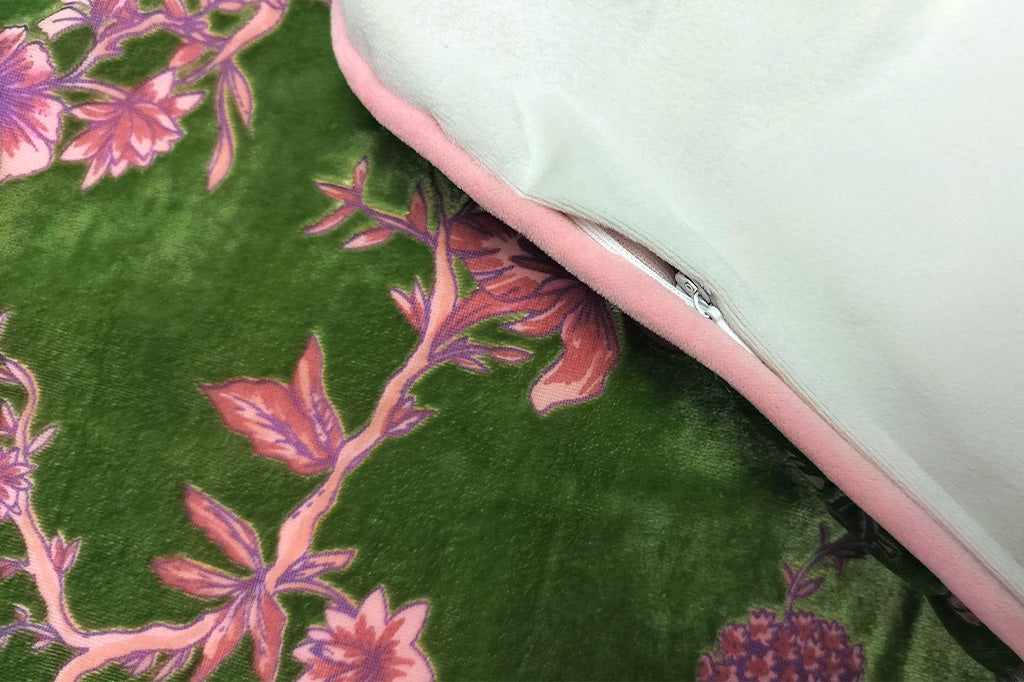 Green pillow with pink floral pattern