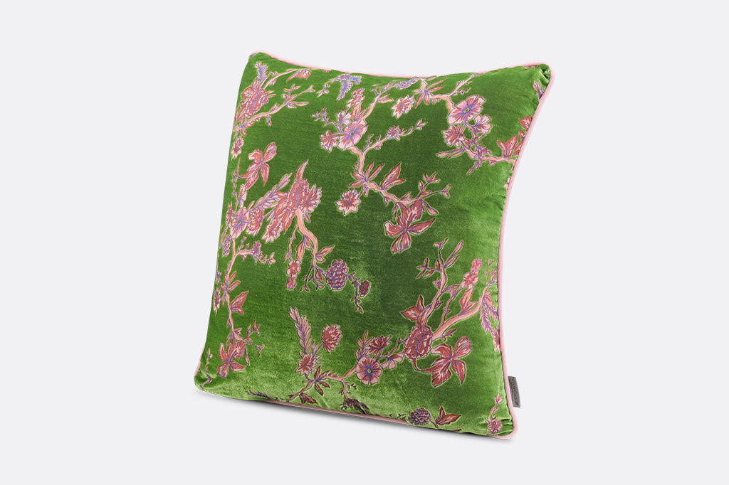 Green pillow with pink floral pattern