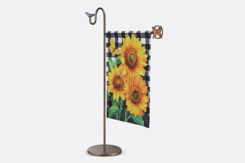 A flag stand with two butterflies and a flag with sunflowers