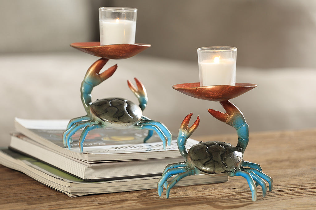 Two crab-shaped sculptures holding candles