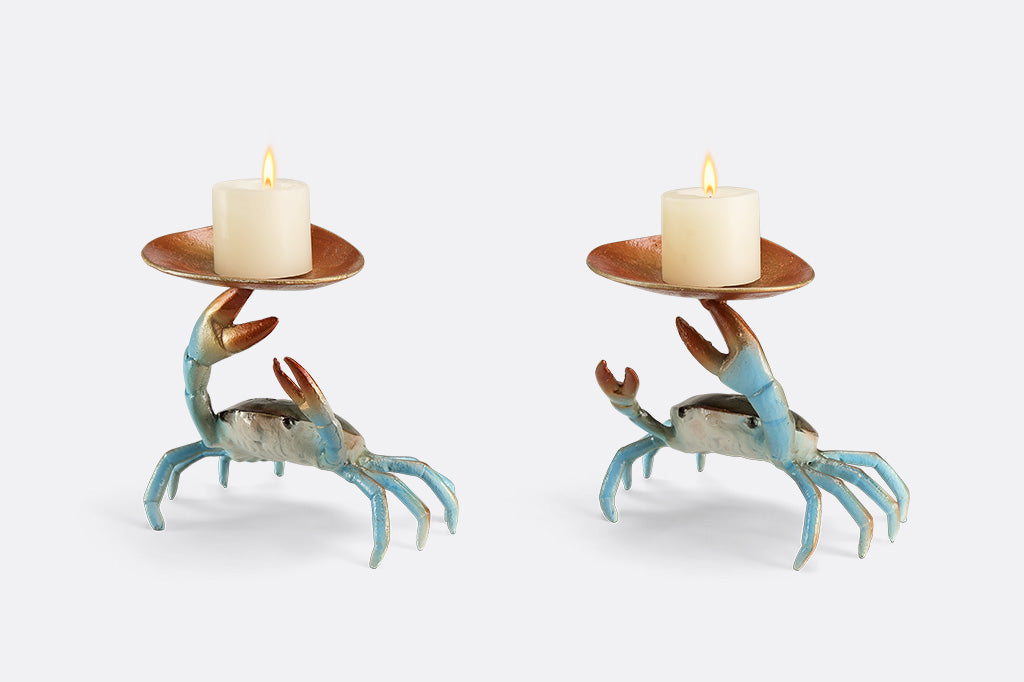 Two crab-shaped sculptures holding candles