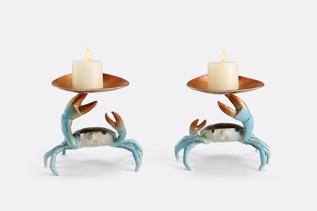 Two crab-shaped sculptures holding candles