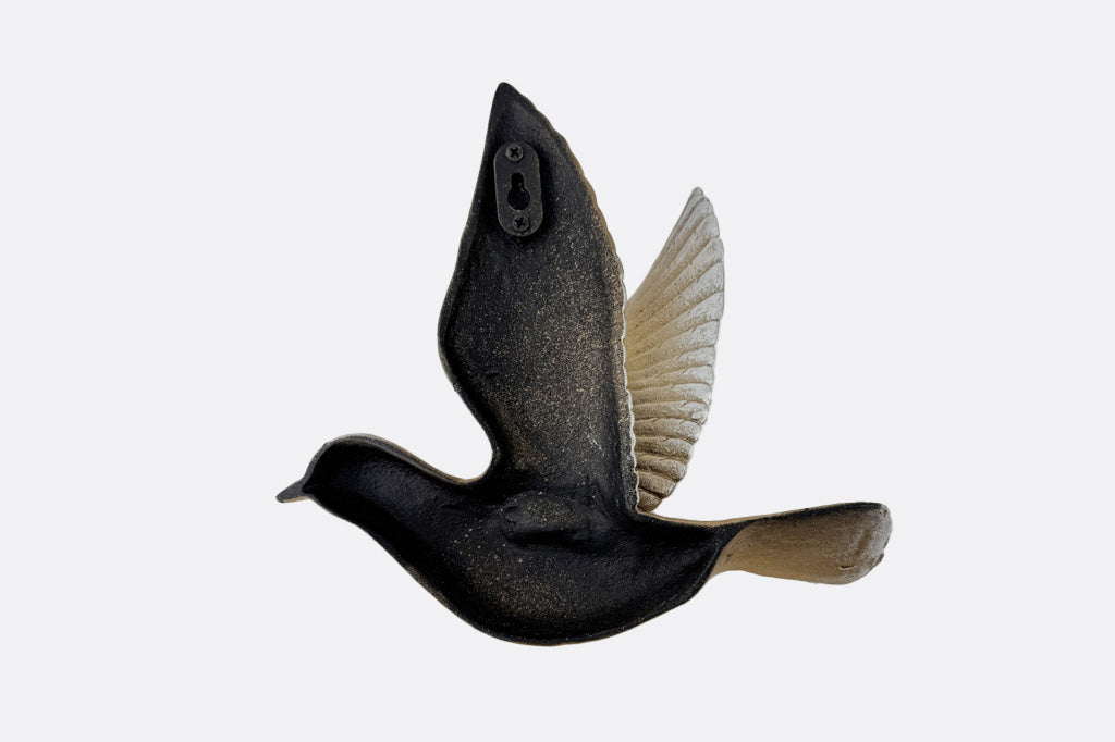 The back of a bird wall art sculpture.