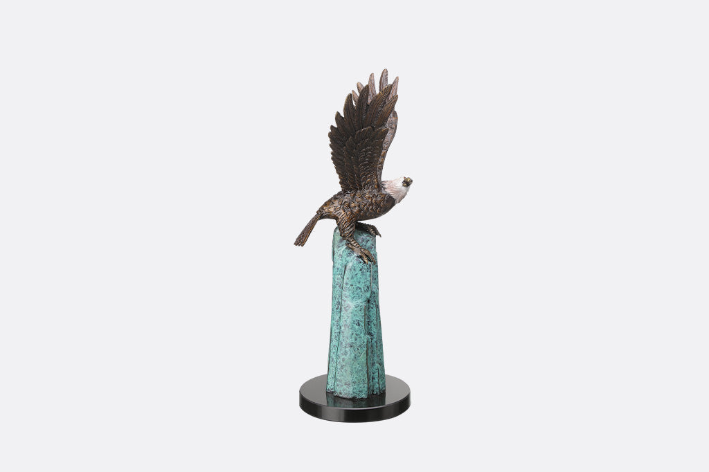An eagle perched upon a stone.
