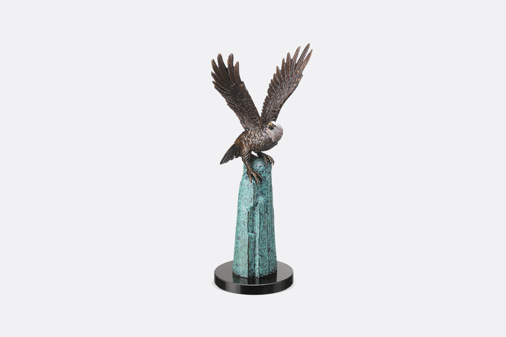 An eagle perched upon a stone.