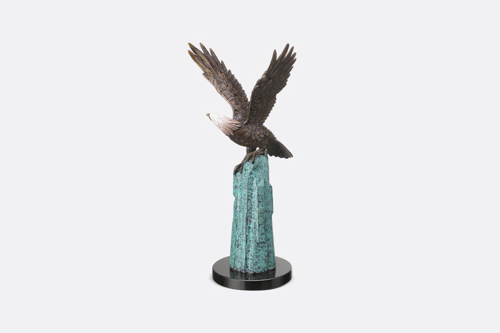 An eagle perched upon a stone.
