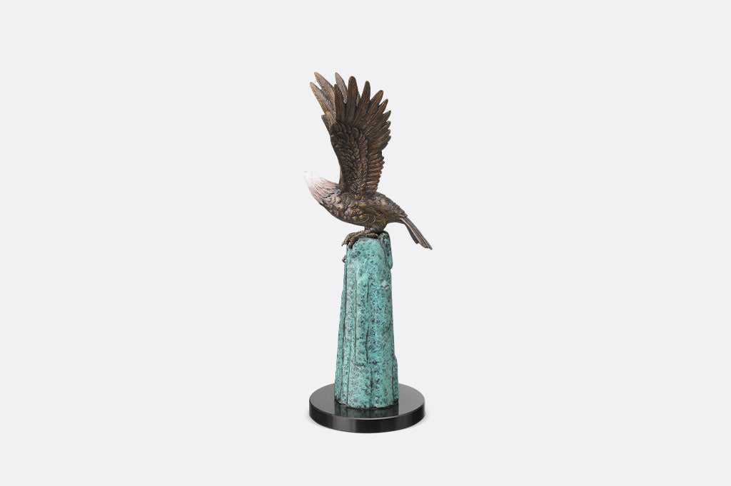 An eagle perched upon a stone.