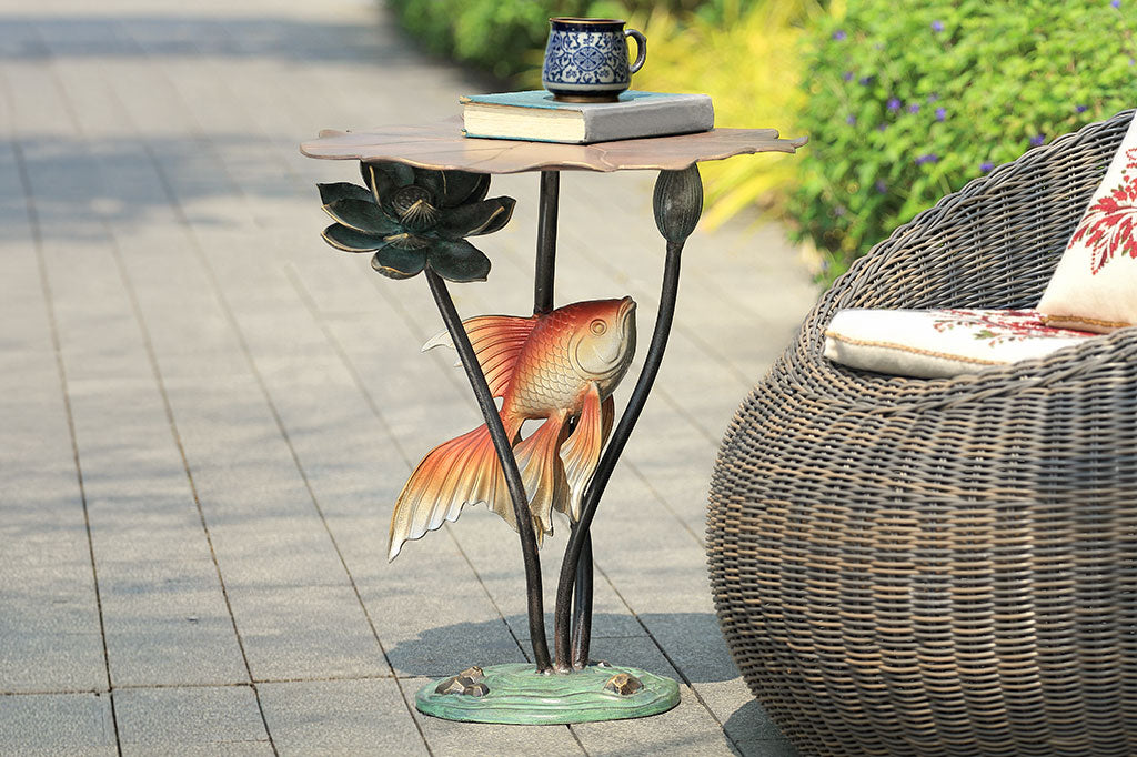 koi fish and water lily accent table shown in garden by outdoor seating