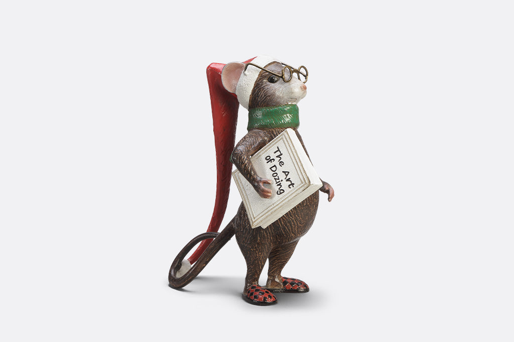 A mouse with glasses, a long night cap, slippers, a green scarf, and a book called "The Art of Dozing."
