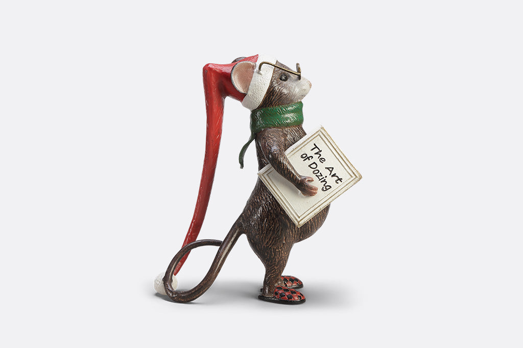 A mouse with glasses, a long night cap, slippers, a green scarf, and a book called "The Art of Dozing."