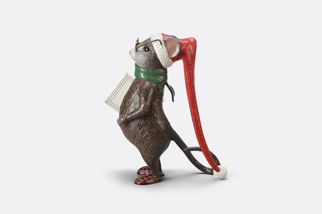 A mouse with glasses, a long night cap, slippers, a green scarf, and a book called "The Art of Dozing."