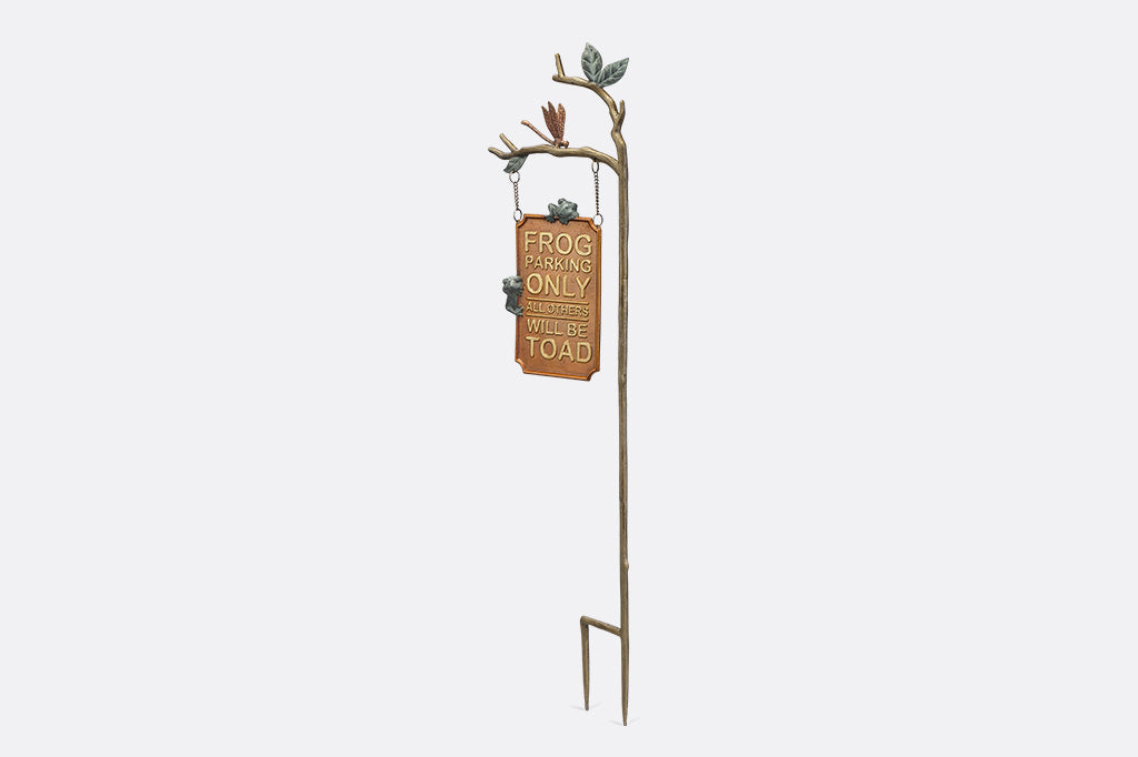 A staked sign with frogs, dragonflies, and branches, with a sign that reads "Frog Parking Only. All others will be toad."