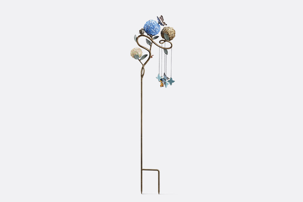 Decorative garden stake with butterflies shot on white background, side view.
