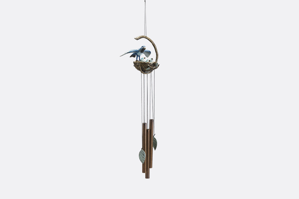 A windchime sculpture featuring a mama blue bird watching over her babies in their nest.