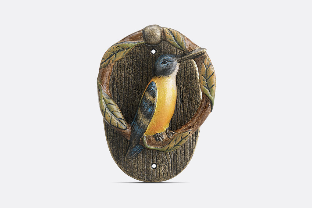 Decorative door knocker with a bird design on a wooden background