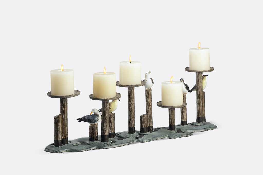 Decorative candle holder with birds on a white background