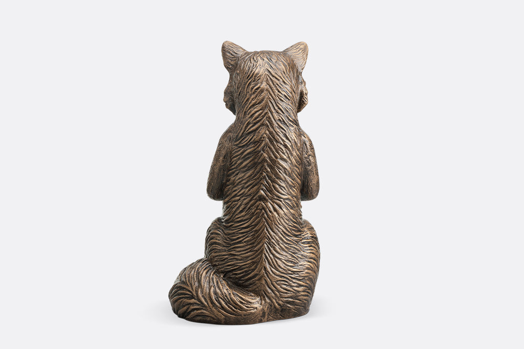 Bronze fox statue on a white background