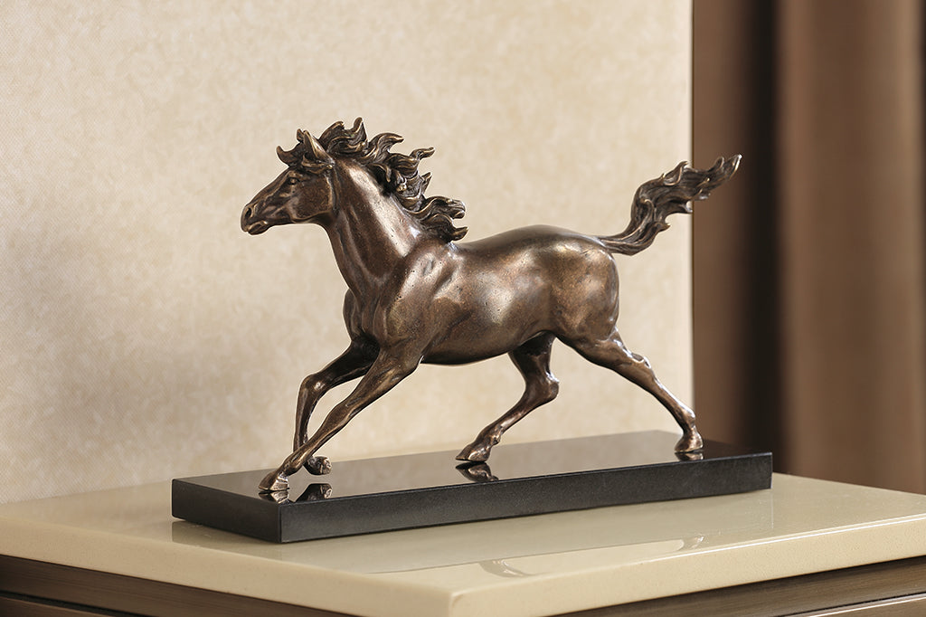 Brass sculpture of a horse running on a marble base.