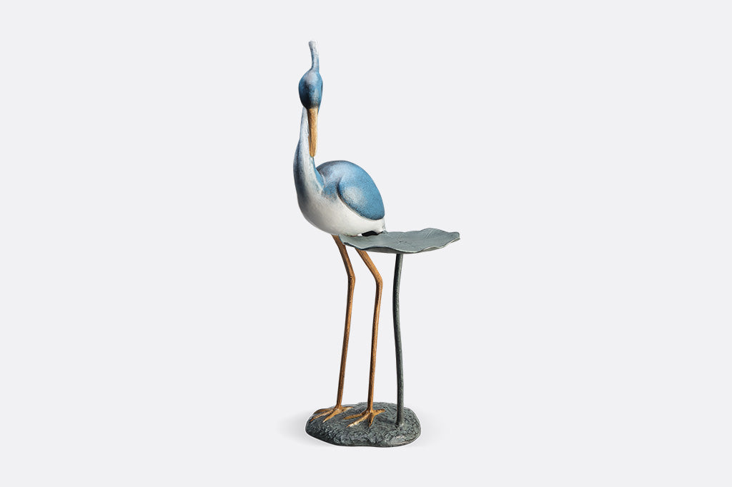 Blue heron figurine on a white background