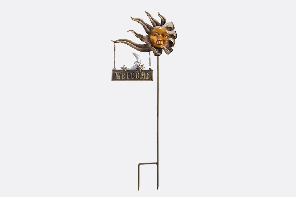 Decorative garden stake with sun face and 'Welcome' sign on a white background