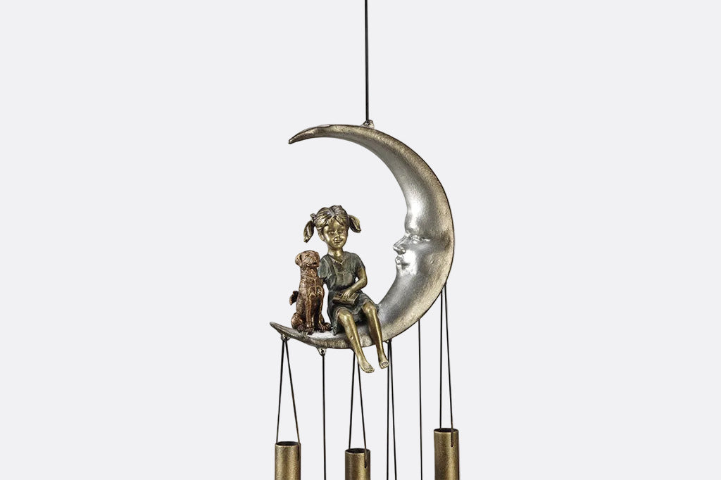 windchime garden decor with girl and pet dog sitting on a crescent moon. bronze tube chimes and star pendants