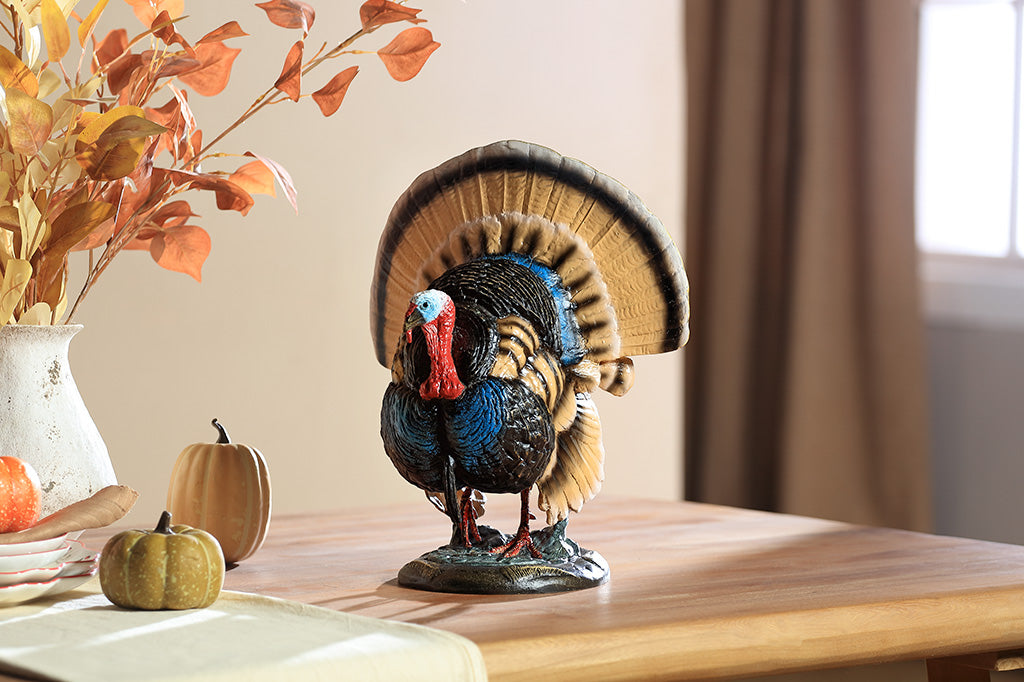 A colorful turkey sculpture with its feathers spread out.