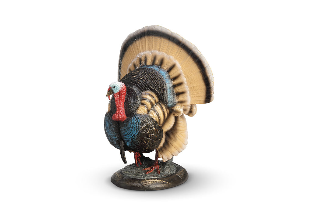 A colorful turkey sculpture with its feathers spread out.