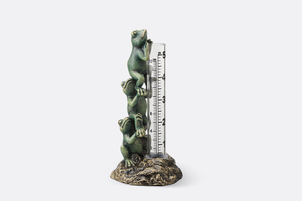 Decorative thermometer with frog design on a white background